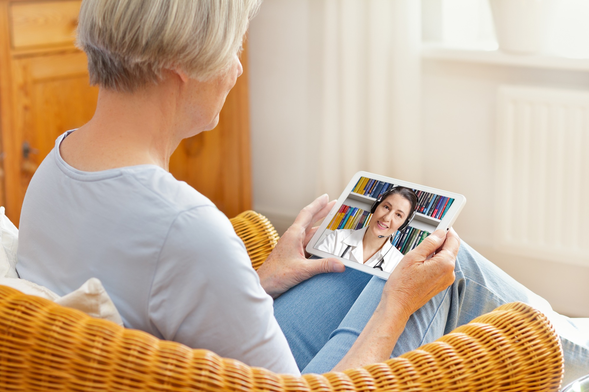 Old woman with tablet pc during an online consultation