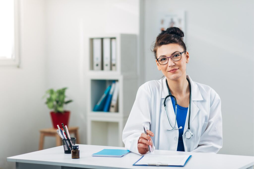 Doctor on her job in Medical Office looking at Camera